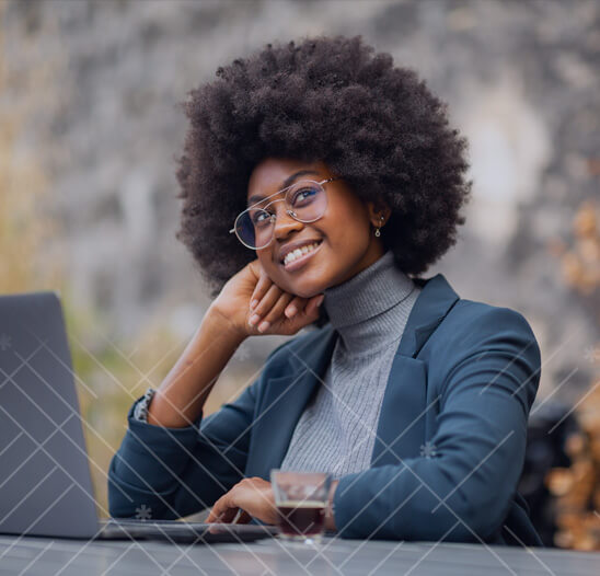 Smiling student with glasses on computer