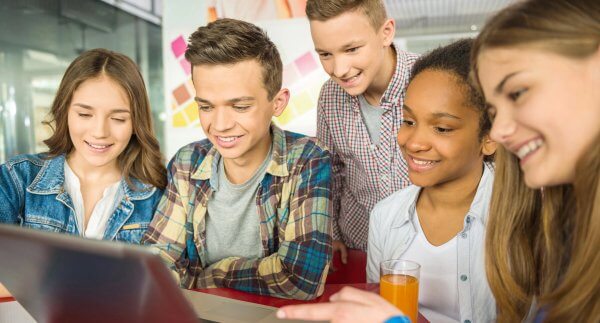 high school students working together at the computer