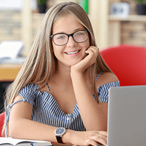 Bright teen female in classes taking a summer coding class